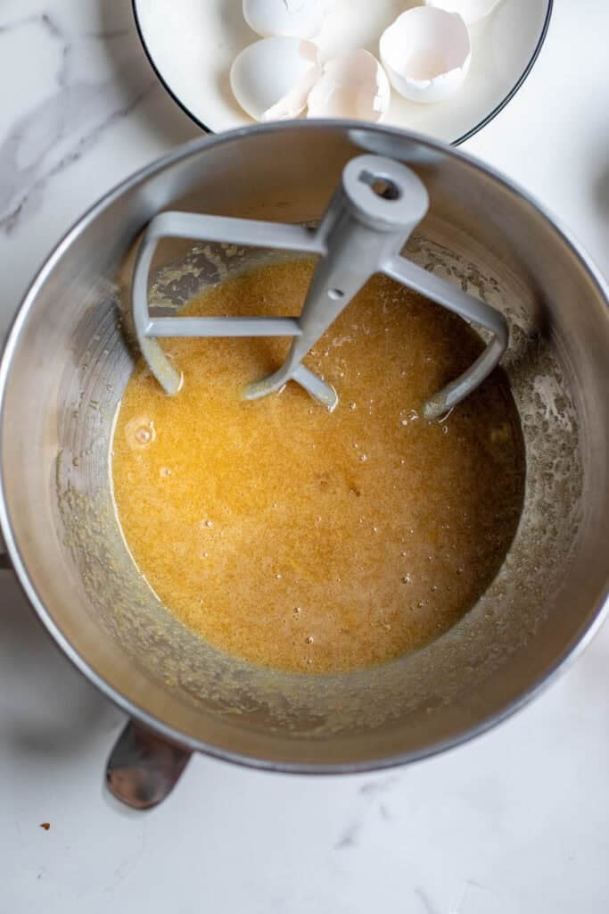 Wet cake ingredients in a stand mixer with a paddle attachment.