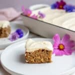 a slice of zucchini cake sitting on a white plate.
