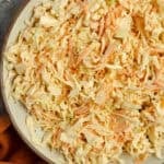 A bowl of coleslaw on the countertop.