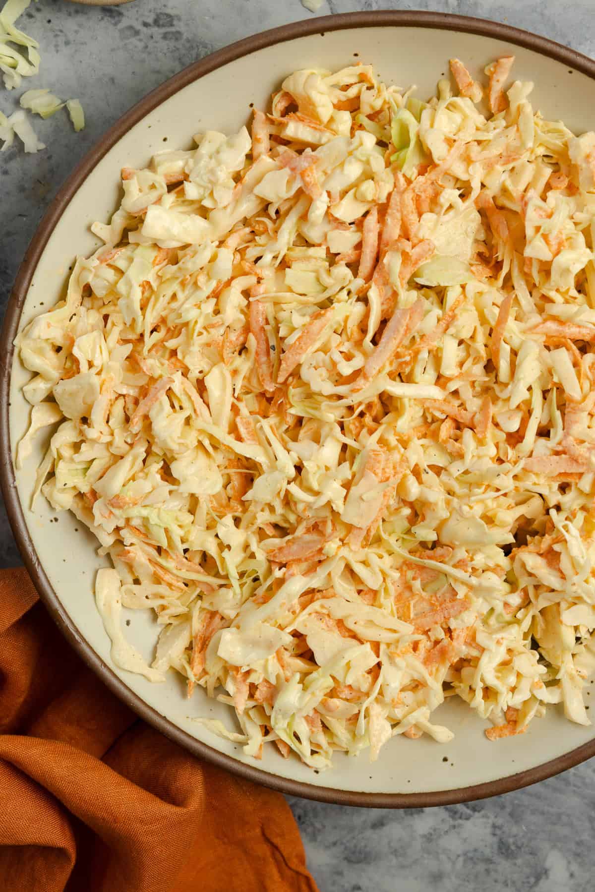 A bowl of coleslaw on the countertop.