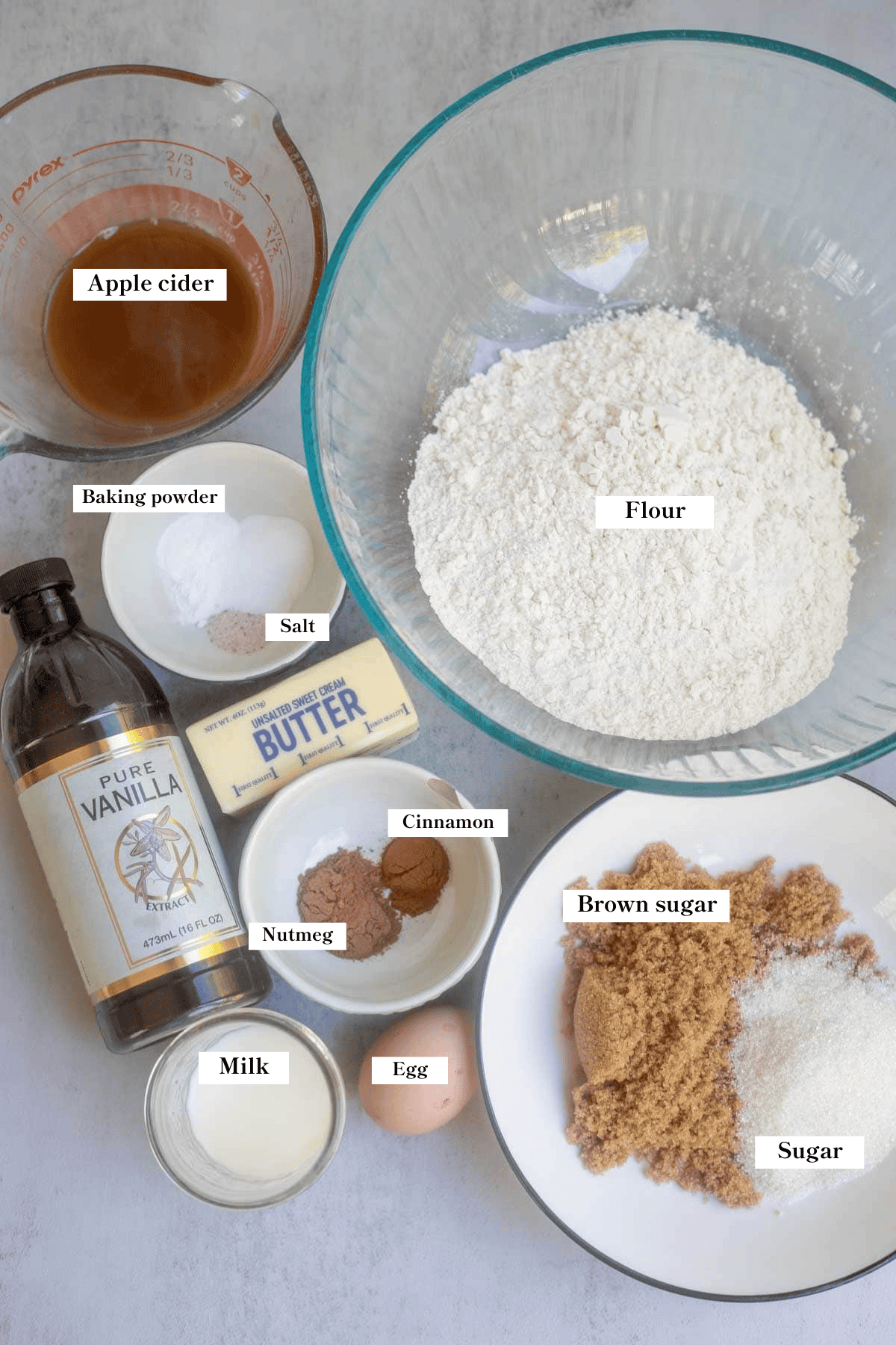 flour, butter, sugar, apple cider and more ingredients on the counter.