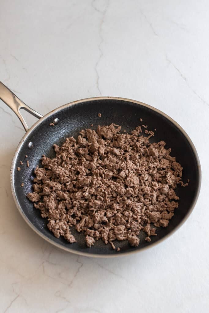 Browning ground beef in a skillet.