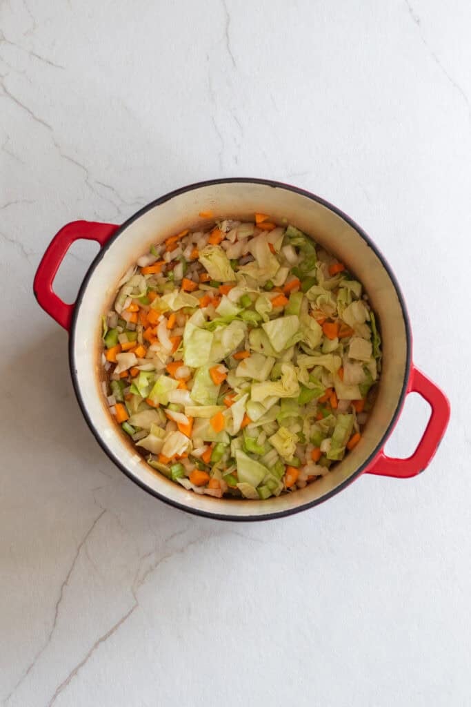 Veggies added to a Dutch oven.