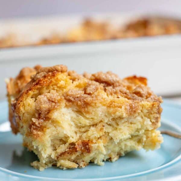 a slice of sourdough french toast casserole on a blue plate.