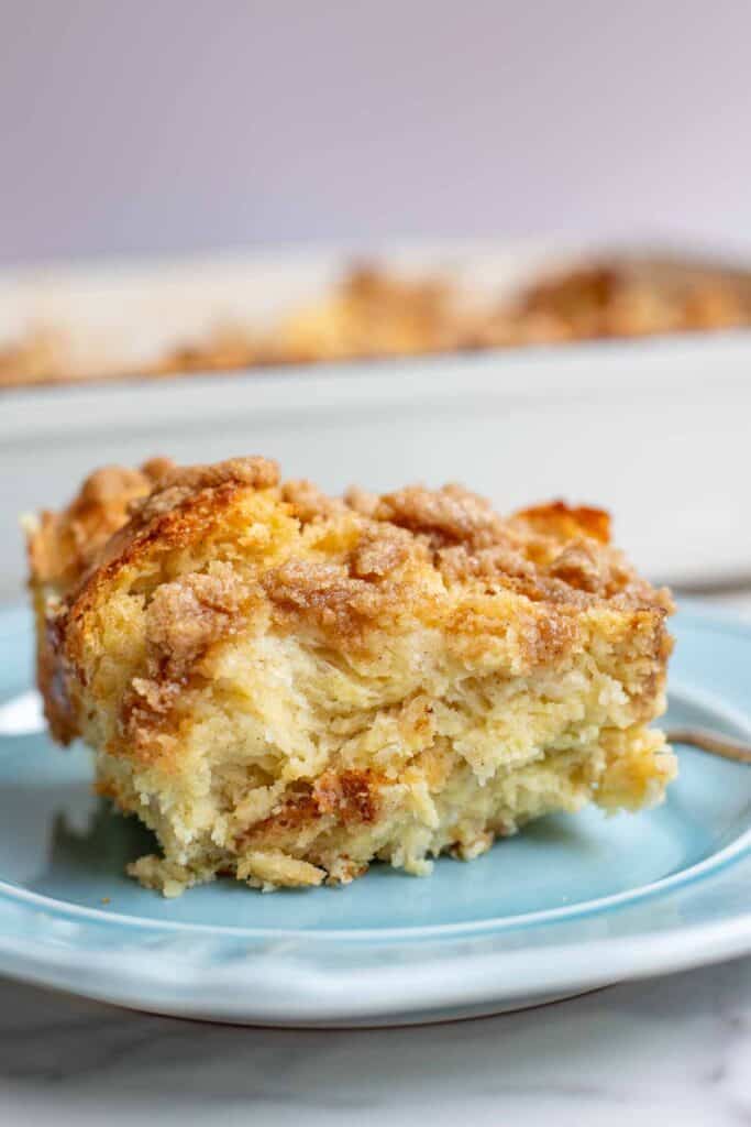 a slice of sourdough french toast casserole on a blue plate.