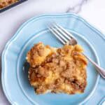 a slice of french toast casserole on a blue plate with a fork.