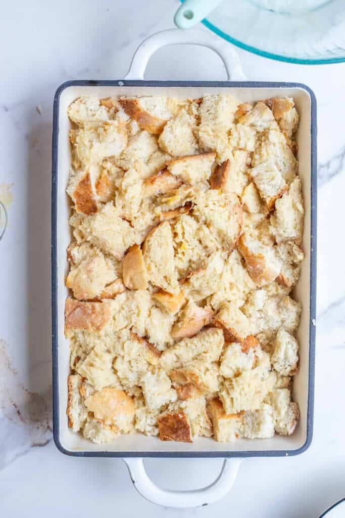 Cubed sourdough bread with the egg and milk mixture poured over the top.