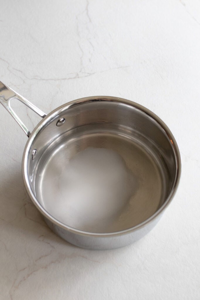 Vinegar, salt, water, and sugar in a saucepan.