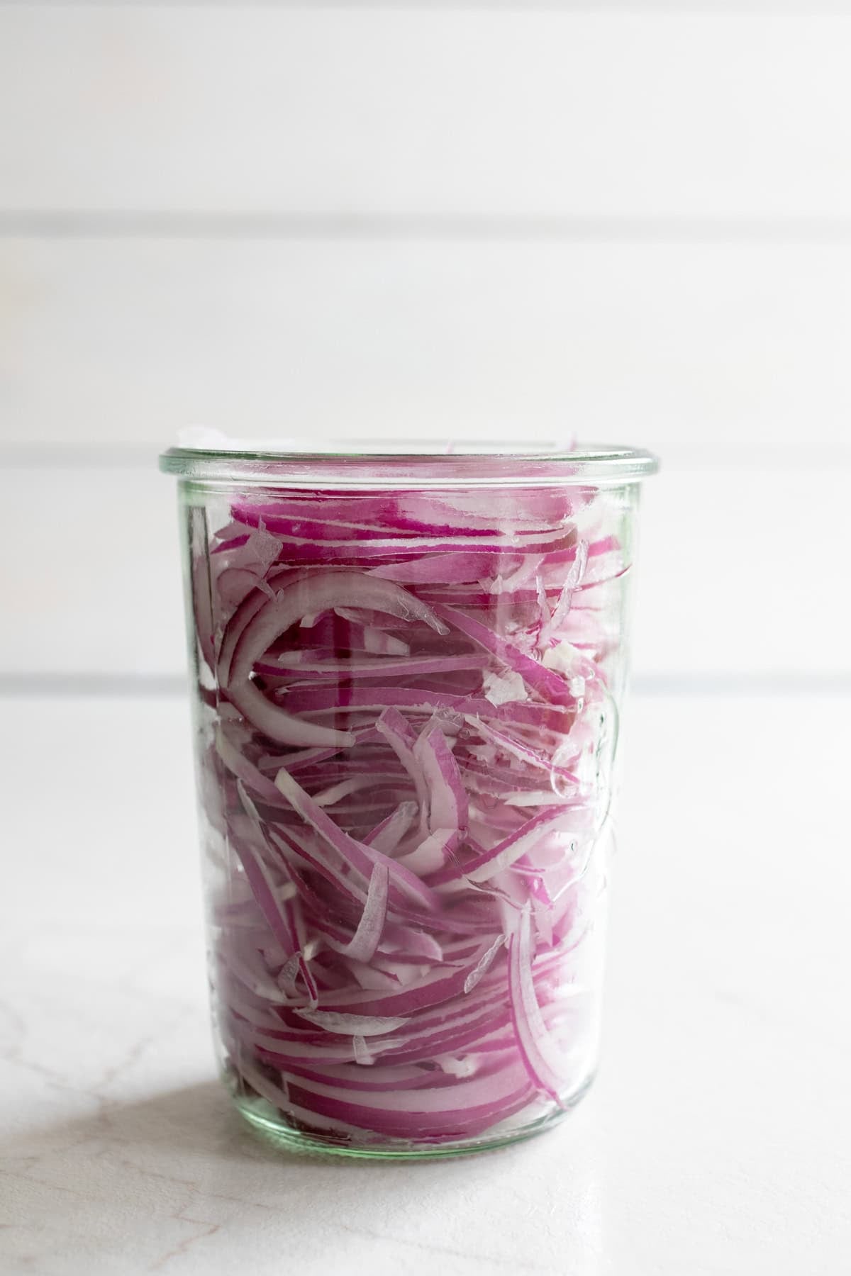 Sliced onions in a jar.