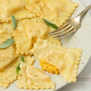 a plate full of butternut squash ravioli.