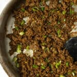 Korean beef with green onions in a skillet.