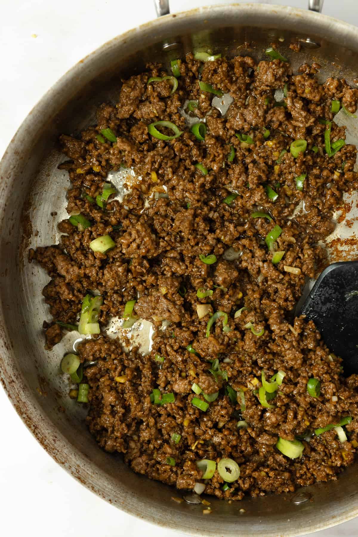 Korean beef with green onions in a skillet.