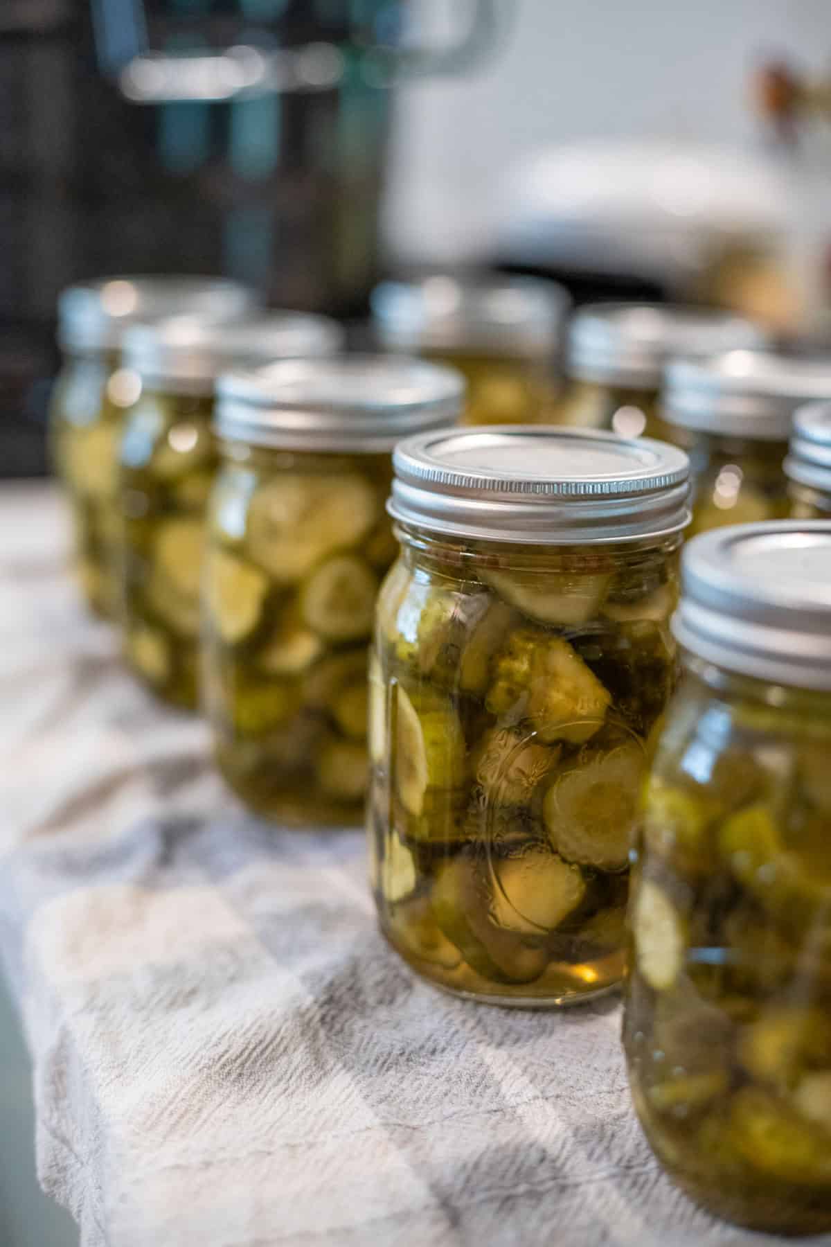Multiple jars of lime pickles on the counter.