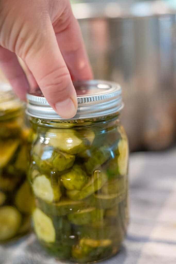 A canned jar of pickles sitting on the countertop.