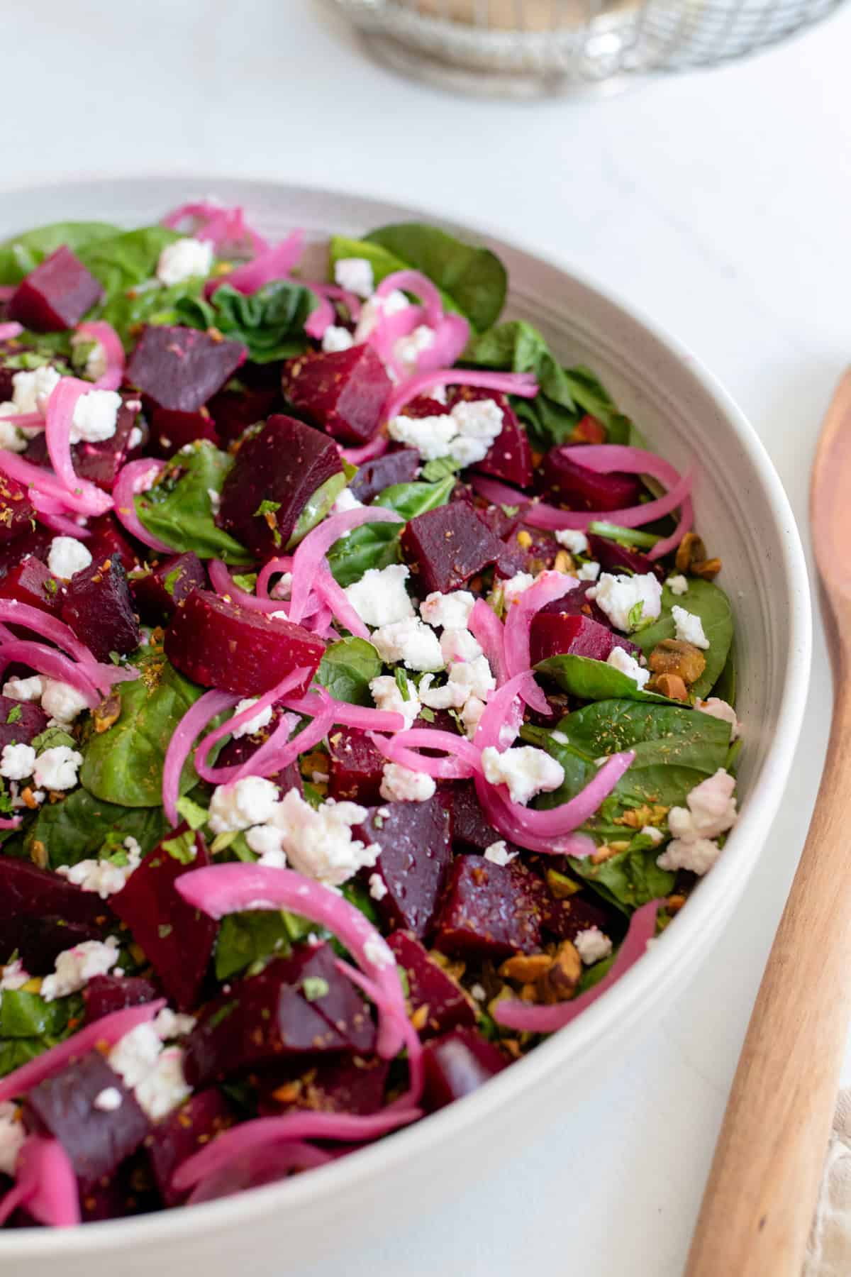 Closeup of a bowl of roasted beet salad.