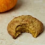 A cookie bitten into on a countertop.