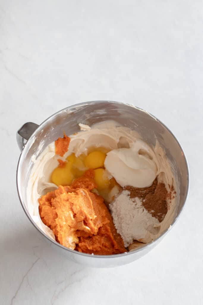 Pumpkin puree, eggs, sour cream, and vanilla mixed into cream cheese.