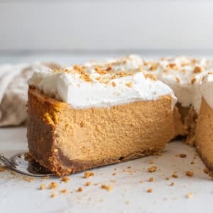 a slice of pumpkin cheesecake on a cake platter.