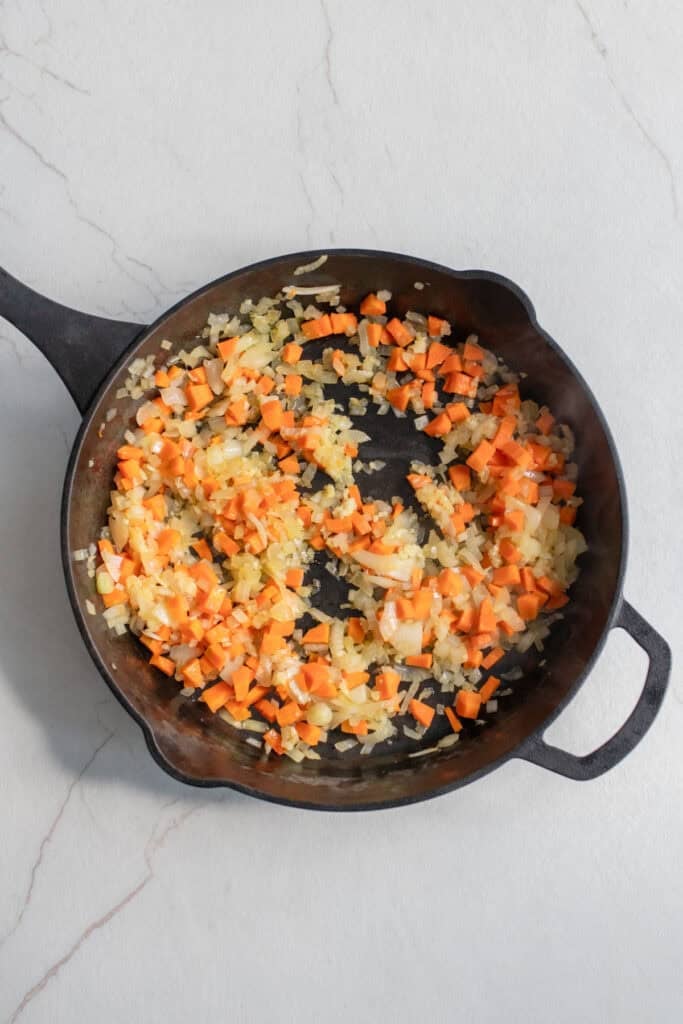 Veggies sauted in a cast iron skillet.