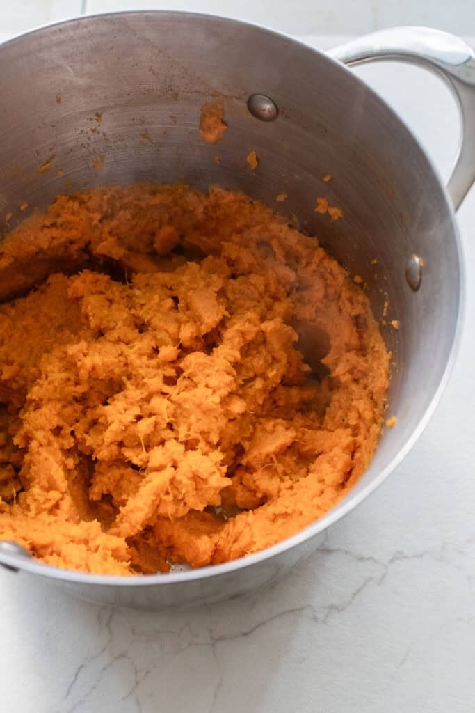 Mashed sweet potatoes in a pot.