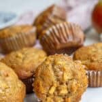 apple banana muffins stacked together on the counter.