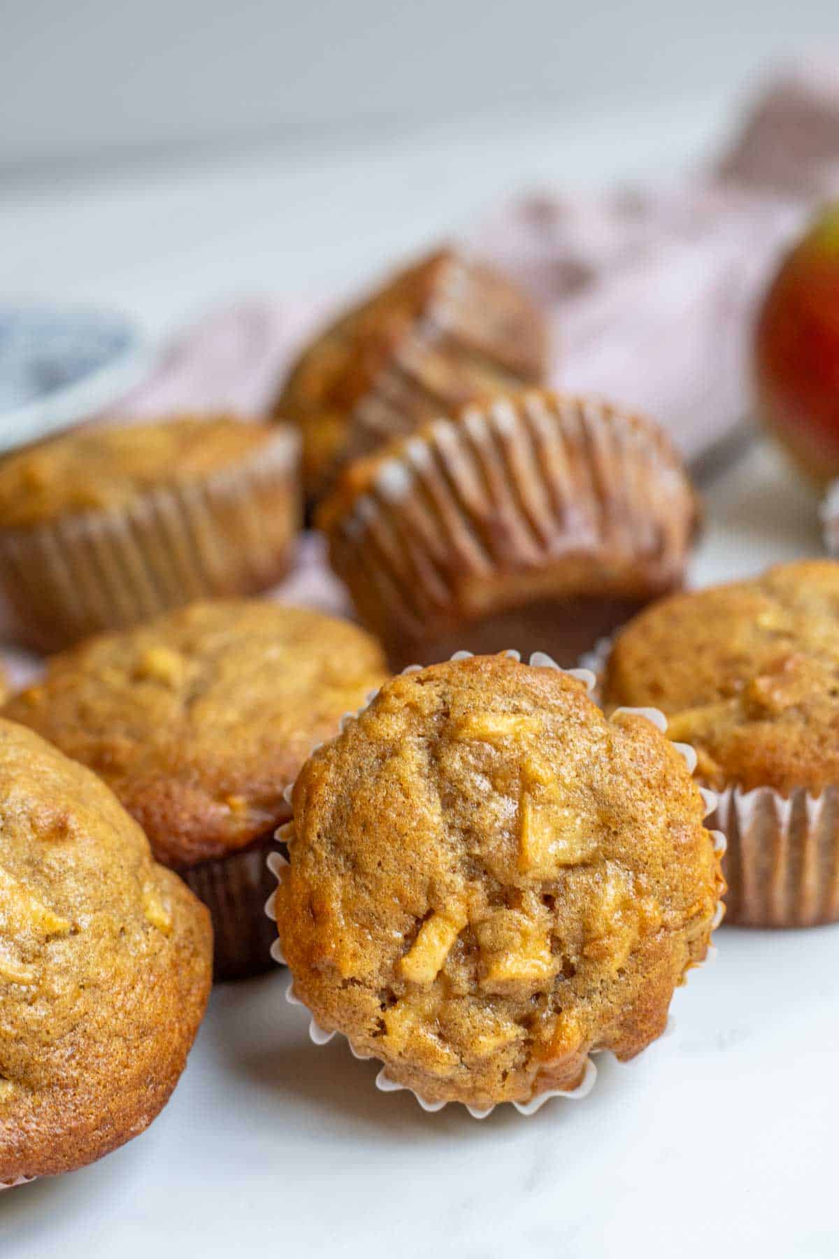 Apple banana muffins stacked together on the counter.