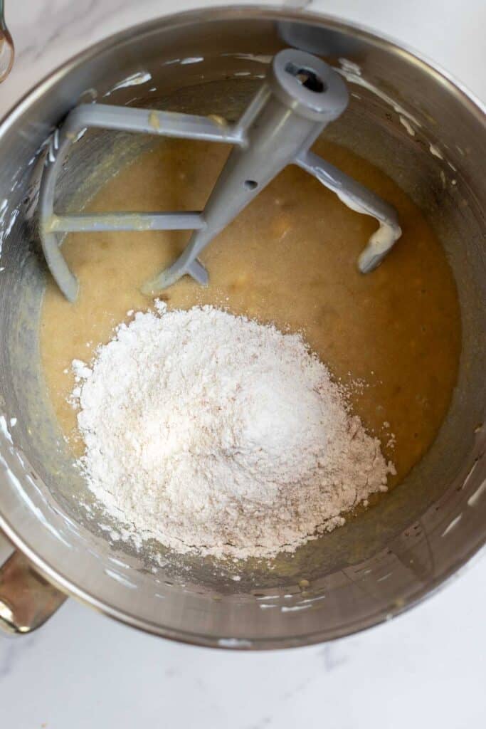 Flour, baking soda, and cinnamon added to the wet ingredients for the muffins. 