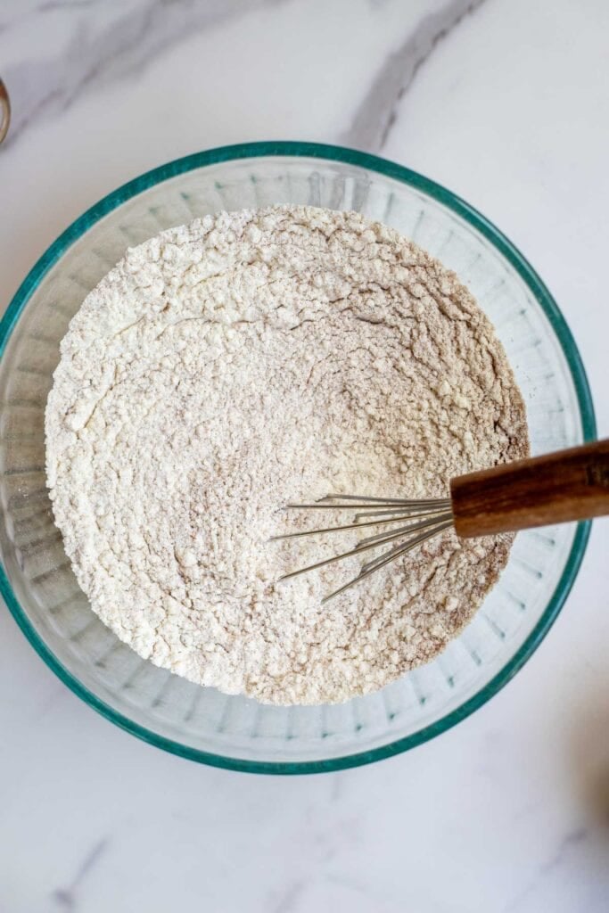 Dry flour ingredients being whisked in a bowl.