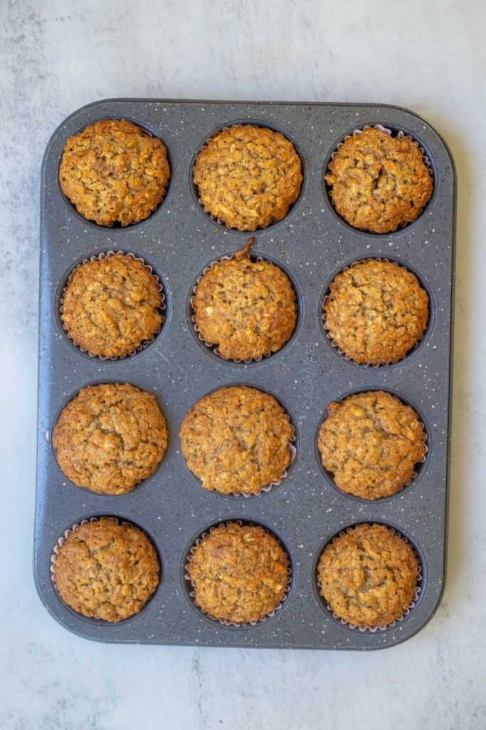 Baked muffins in a muffin tin fresh out of the oven.