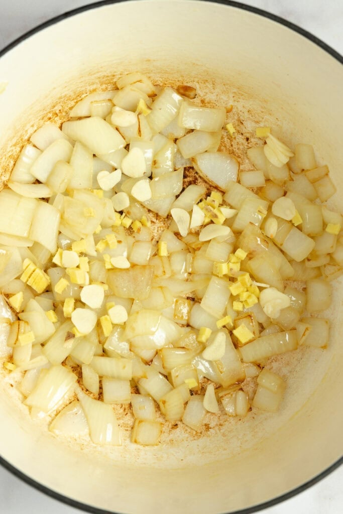 Garlic, onion, and ginger cooking in a large pot.