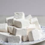 a stack of marshmallows on a decorative plate.
