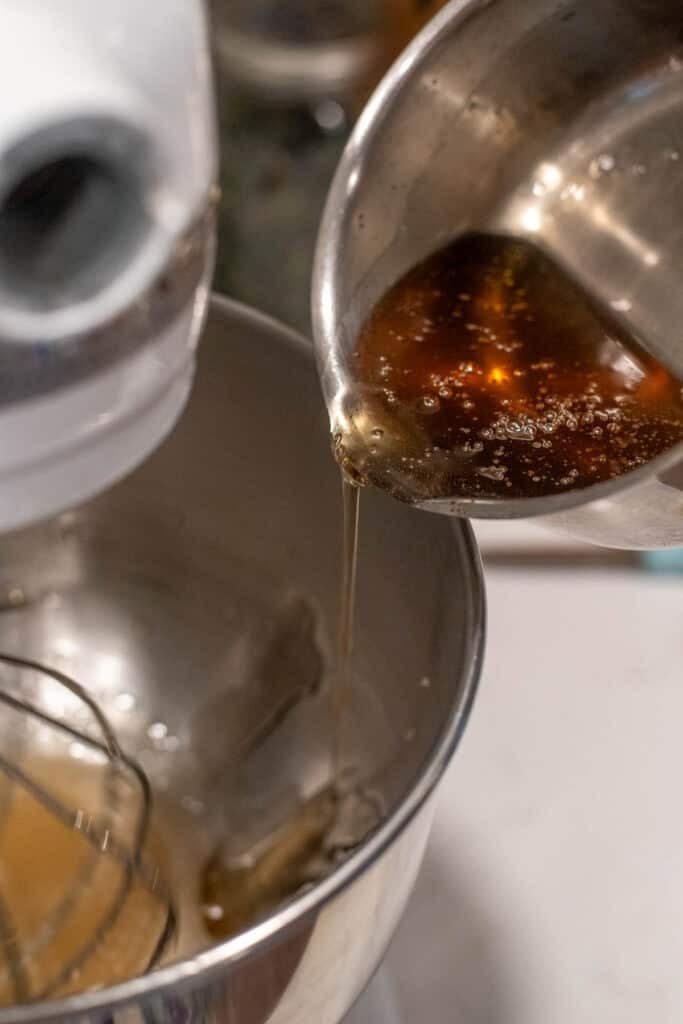 Pouring the boiled gelatin mix into a stand mixer to make gelatin fluff.