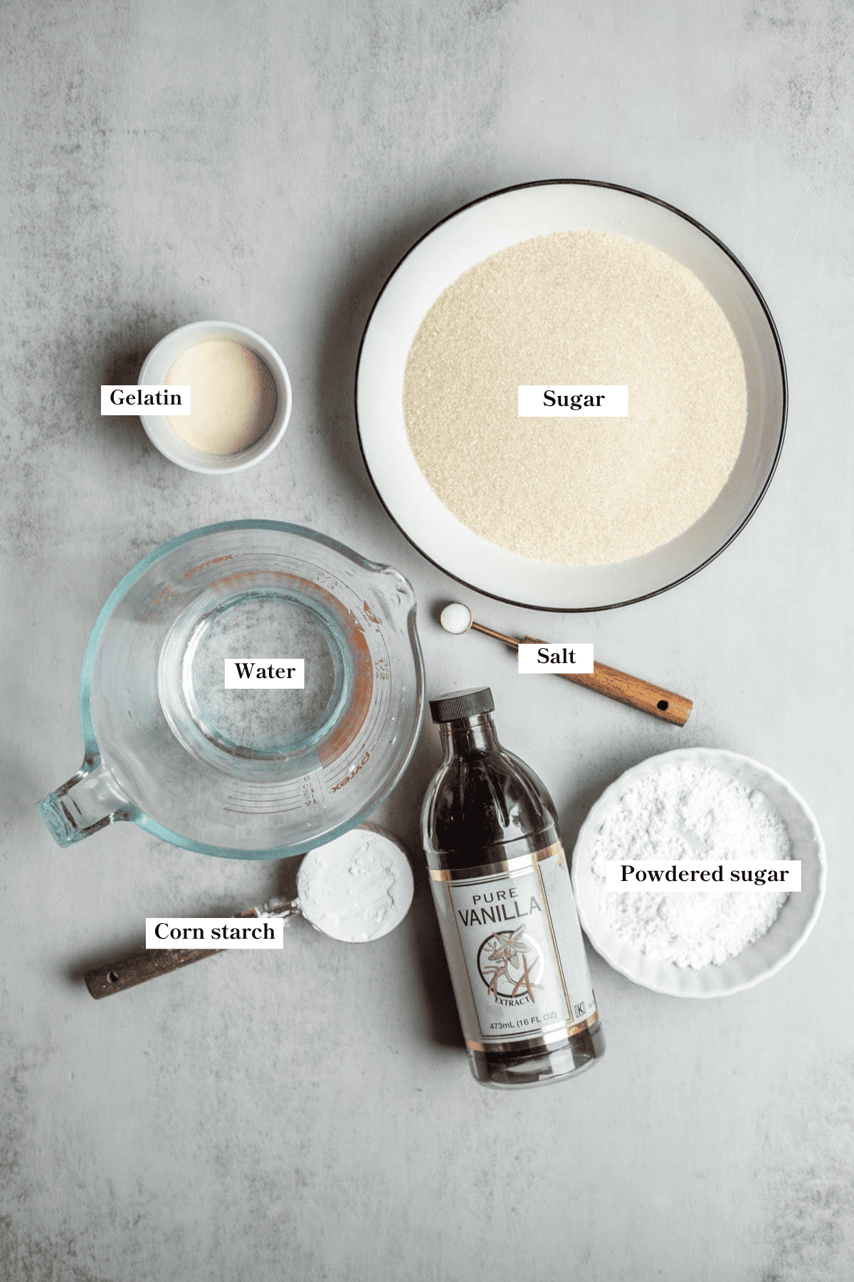 Sugar, gelatin, vanilla, powdered sugar, and other ingredients on the counter.