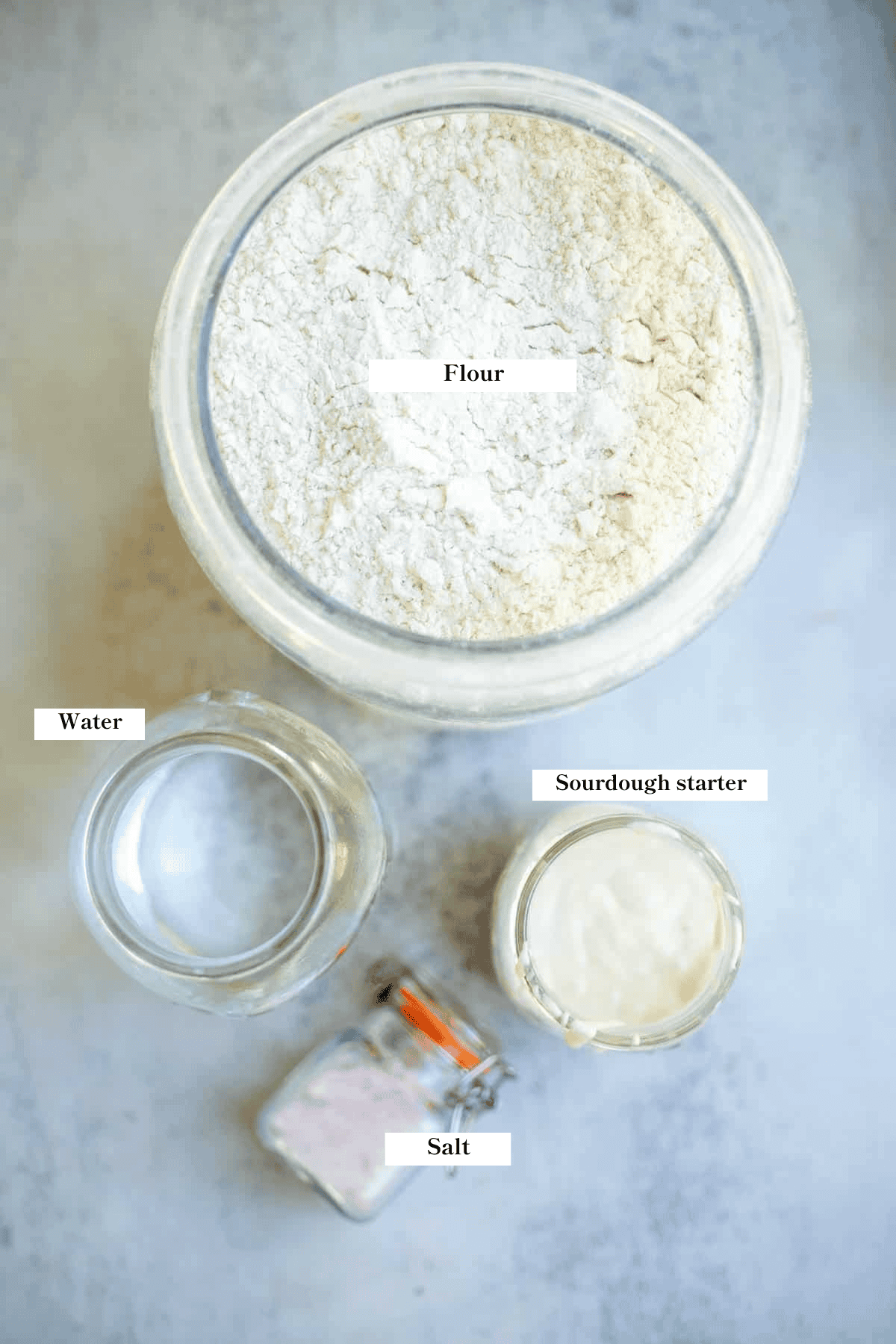 Flour, sourdough starter, water, and salt on the counter.