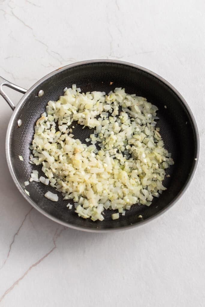 Garlic and butter sautéing in a pan.