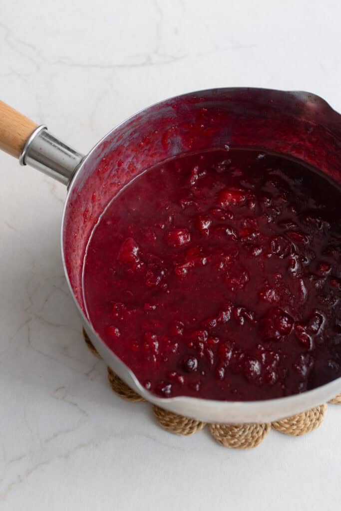 Cooked cranberries in a large pot.