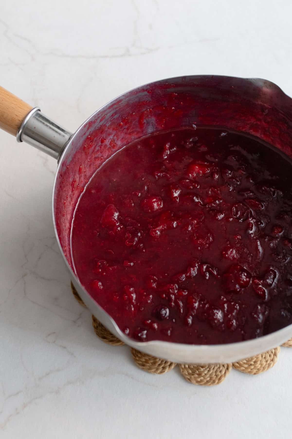 Cooked cranberries in a large pot.