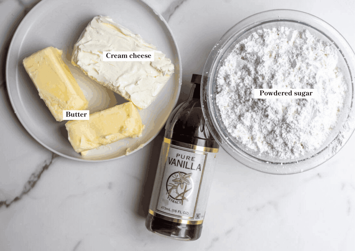 cream cheese, butter, vanilla, and powdered sugar on the counter.