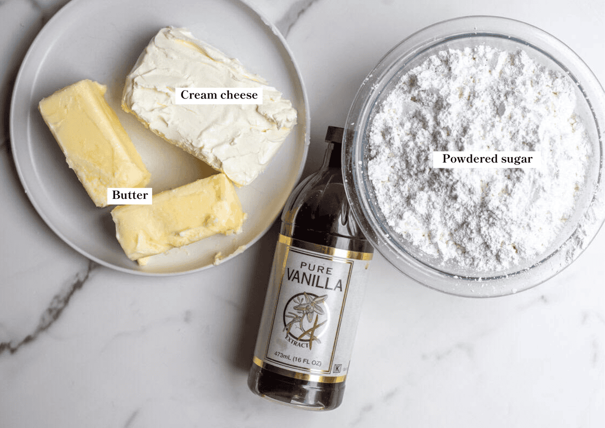 cream cheese, butter, vanilla, and powdered sugar on the counter.