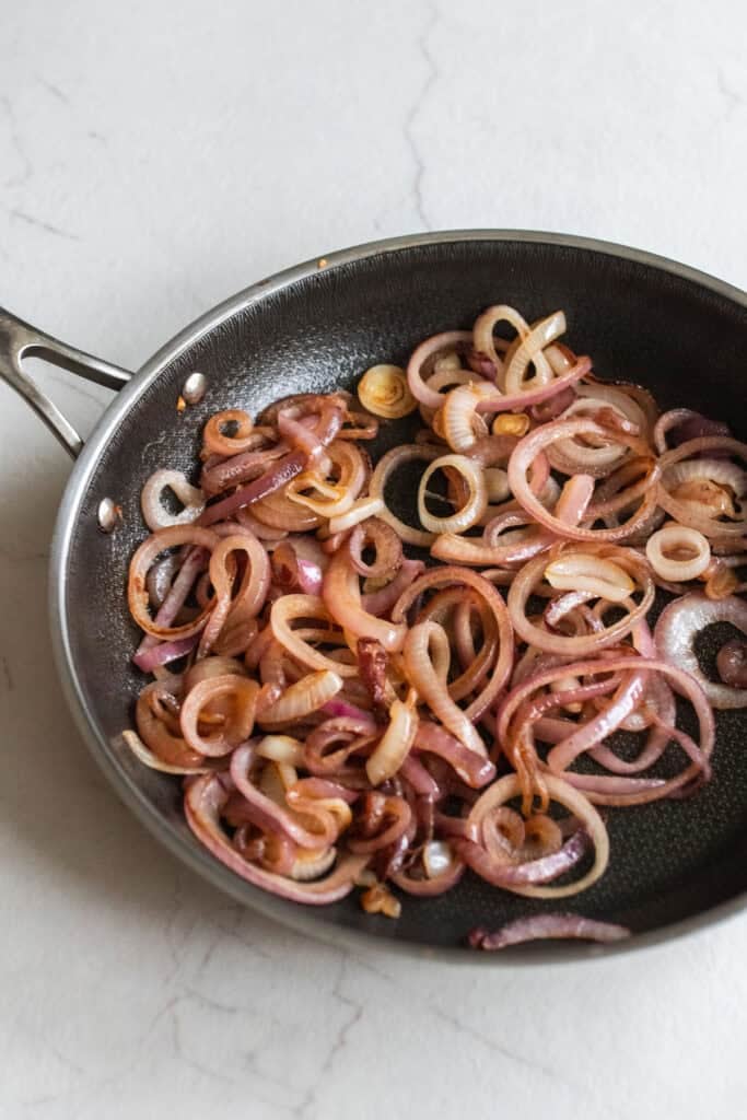 Sliced onions caramelized in a skillet.