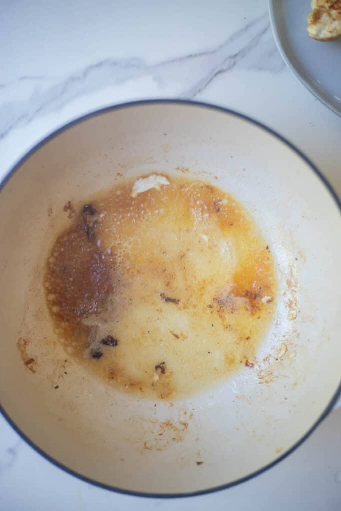 A Dutch oven deglazed with white wine.