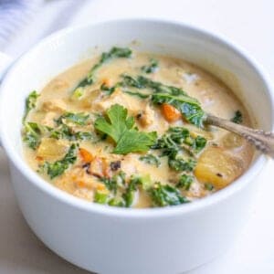 A bowl of soup with a spoon in it.