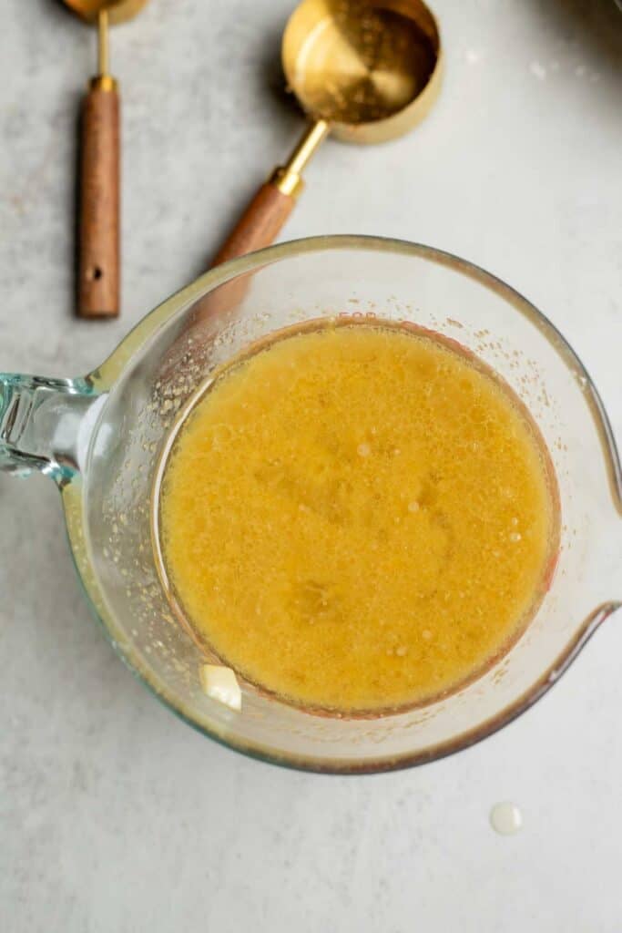 Oil, eggs, vanilla, and milk mixed together in a glass bowl.