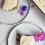 two pieces of cake on two small white plates.