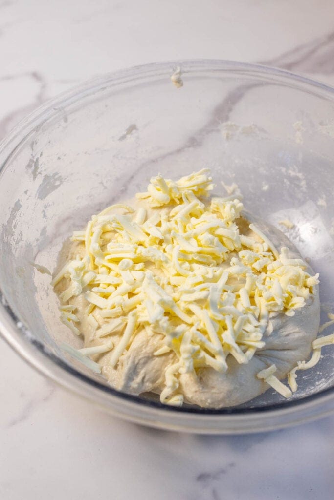 Butter grated in a glass bowl.