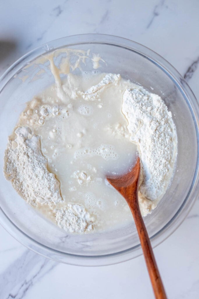 Flour, water, and sourdough starter mixed together in a bowl.