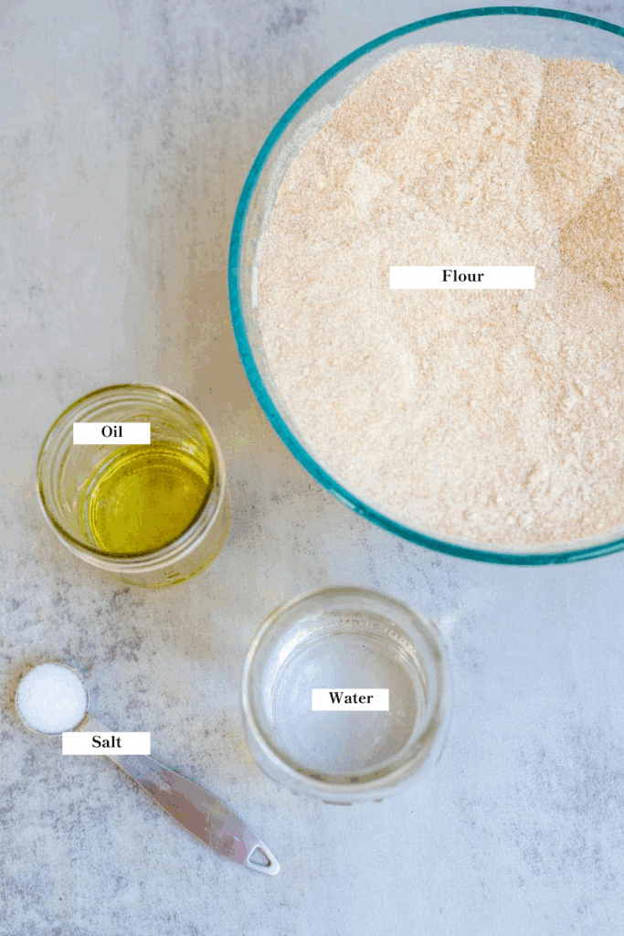 bowls of flour, oil, water, and salt on the kitchen counter.