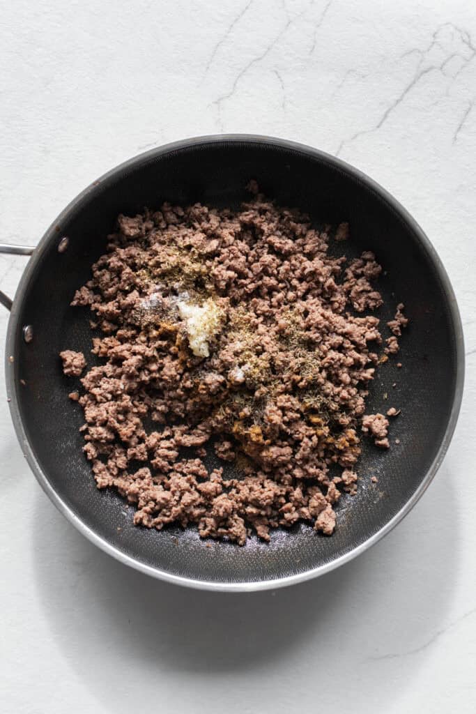 Ground beef cooked in a skillet.