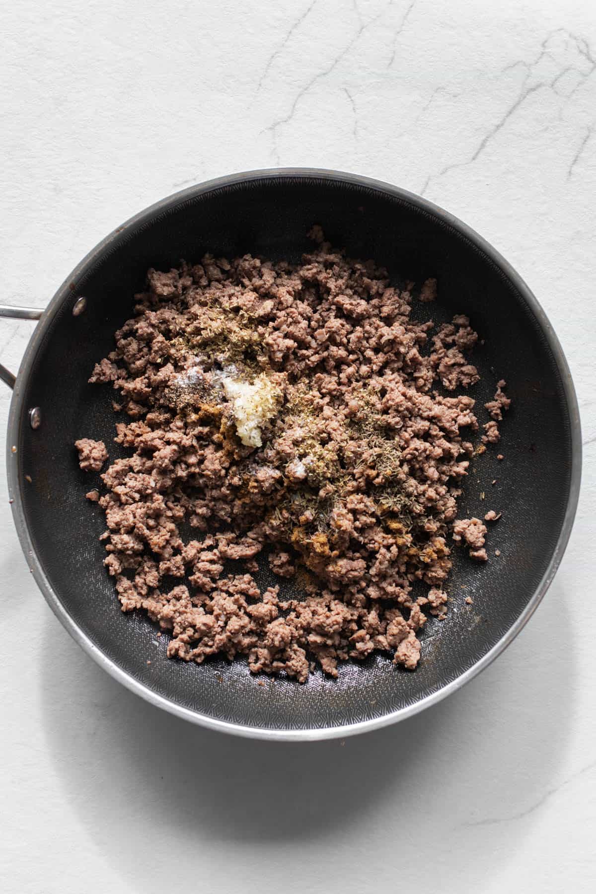 Ground beef cooked in a skillet.