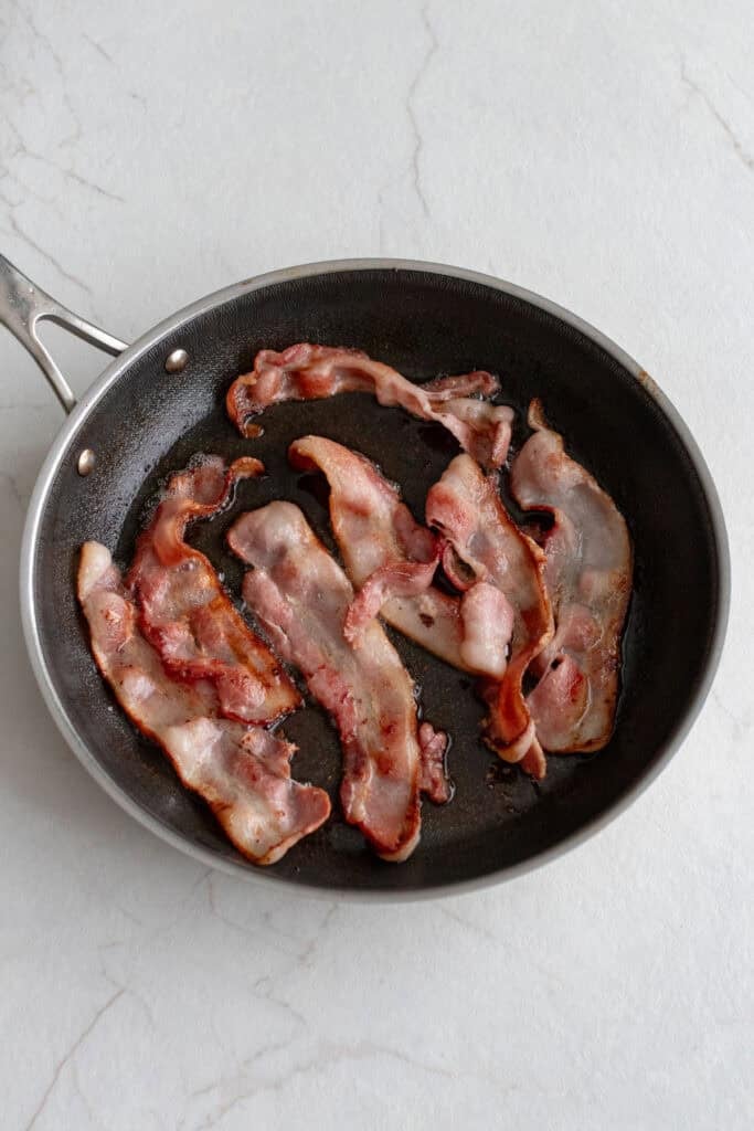 Bacon in a skillet.